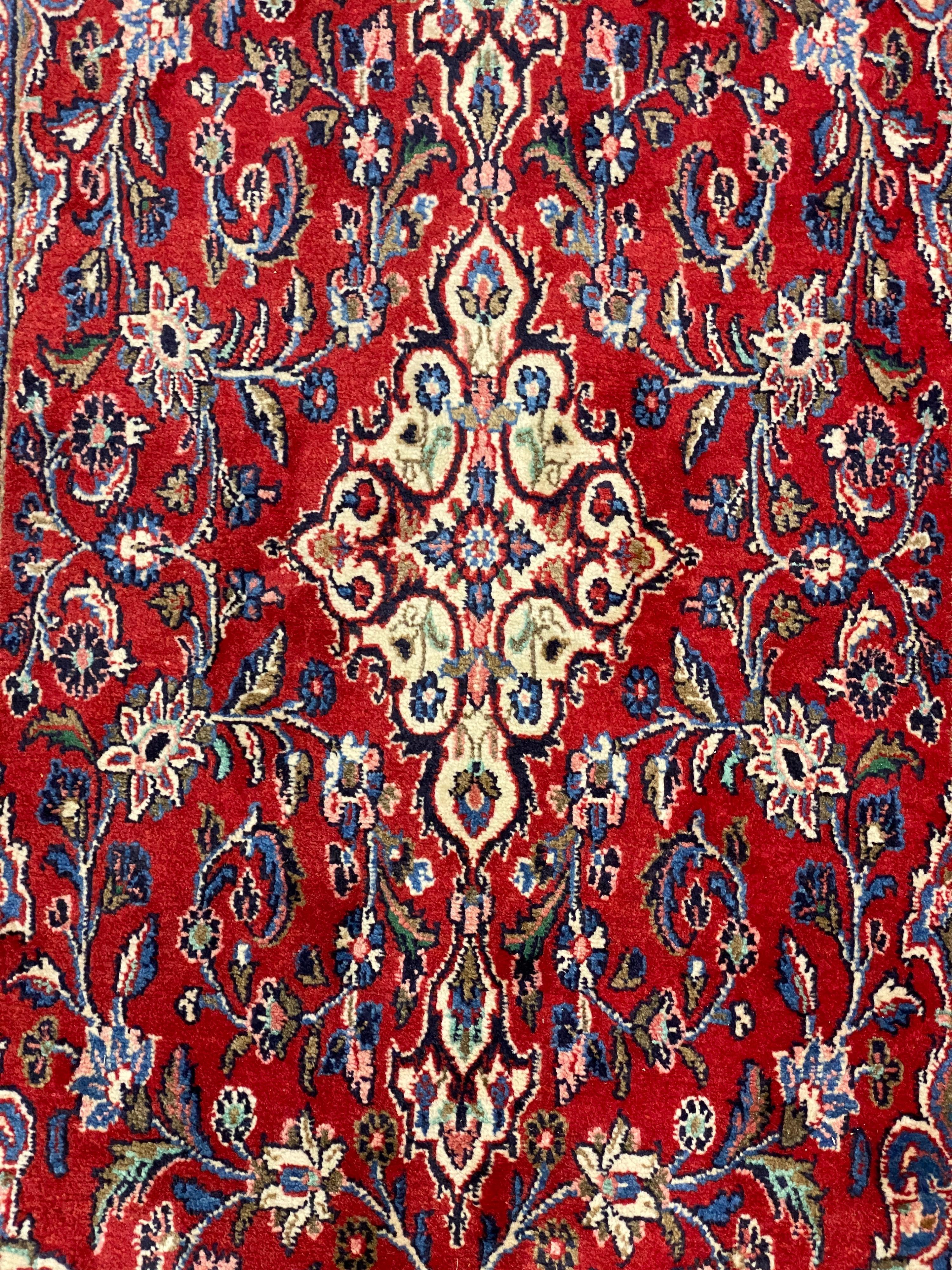 A Northwest Persian red ground rug, 240 cm x 136 cm